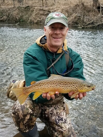 Missouri-fly-fishing-guide-Mike-holding-a-brown